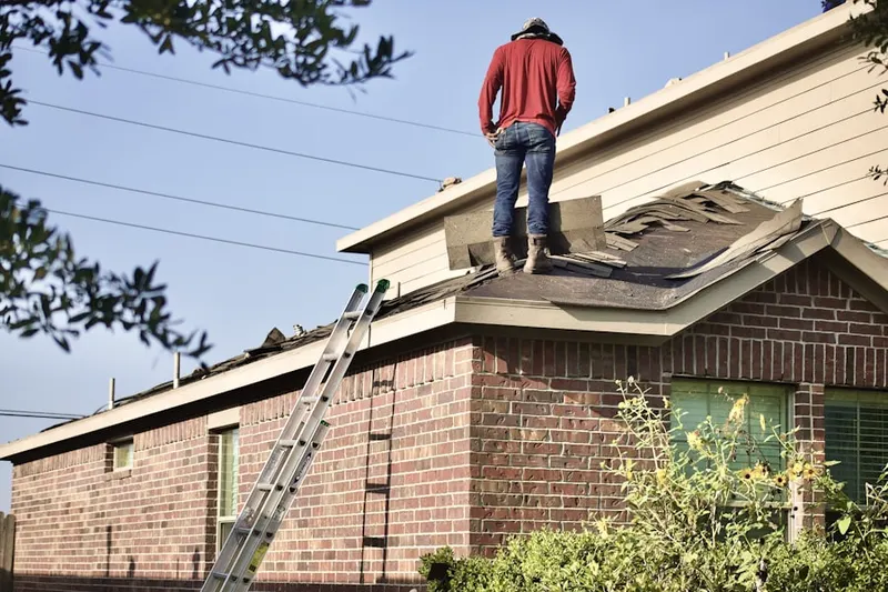 Professional roofer working on a residential roof in Lake Station